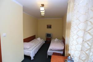Postel nebo postele na pokoji v ubytování Hotel Kakadu