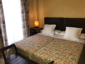 Un pat sau paturi într-o cameră la Hotel Lince