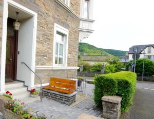 a wooden bench sitting outside of a house at Ferienwohnung Michels in Bernkastel-Kues