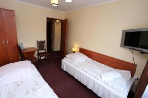 Postel nebo postele na pokoji v ubytování Hotel Kakadu