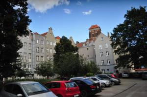 a row of cars parked in front of a building at Tawerna Rybaki Old Town in Gdańsk