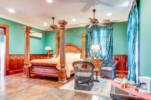 a bedroom with a canopy bed and green walls at Colonial Suite @ Mahogany Hall in San Ignacio