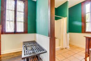 a bathroom with green walls and a bench at Colonial Suite @ Mahogany Hall in San Ignacio