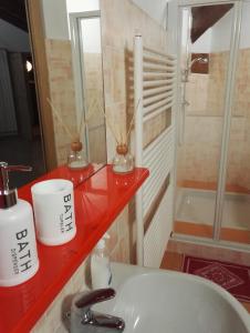 a bathroom with a sink and a red counter at BED & BREAKFAST AL BRICCO in Cantarana