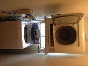 a microwave and a washing machine in a room at Beppu Yukemuri-no-oka Youth Hostel in Beppu +7 photos