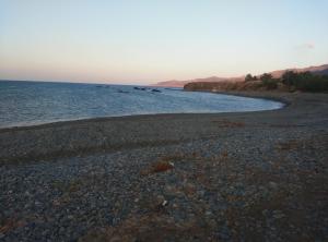 a rocky beach with the ocean in the background at Pomos Harbourbiew Villa in Pomos