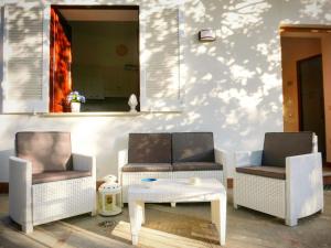 two chairs and a table and a mirror on a wall at Acquamarina Accommodation in Massa Lubrense