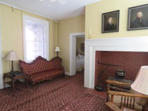 a living room with a couch and a fireplace at The Swope Manor Bed & Breakfast in Gettysburg