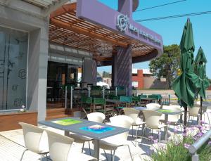 a patio with tables and chairs in front of a restaurant at Hotel Los Naranjos in General Deheza