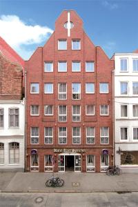 a large red brick building with a cross on it at Hotel Alter Speicher in Lübeck