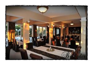 a dining room with a table and chairs at Belveder Deluxe Suite and Rooms in Supetarska Draga