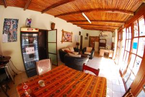 a dining room with a table and a living room at Los Faroles Pacasmayo in Pacasmayo