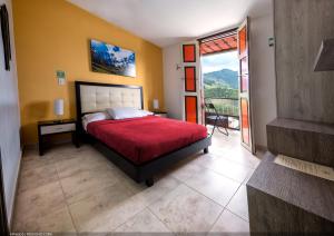 a bedroom with a bed with a red bedspread at Casa Borbon in Salento