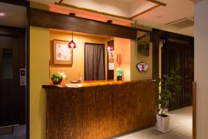 a hotel lobby with a wooden counter top at Matsubaya Ryokan in Kyoto