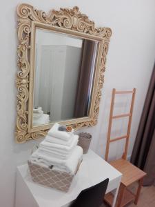 un miroir et un tas de serviettes sur une table dans l'établissement L'Angoletto, à Ciampino