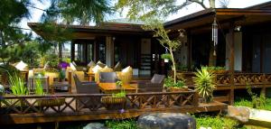 Casa con terraza de madera con sillas y mesa en Flower Free花自在, en Zhuolan