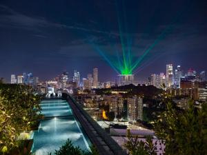 a view of a city skyline at night at JEN Singapore Orchardgateway by Shangri-La in Singapore
