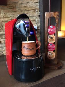 a coffee maker with a cup on top of it at Panviman Resort Koh Phangan - SHA Extra Plus in Thong Nai Pan Noi
