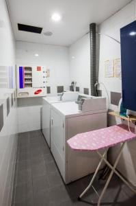 a kitchen with a pink table and a sink at Western Coop Hotel & Residence Dongdaemun in Seoul