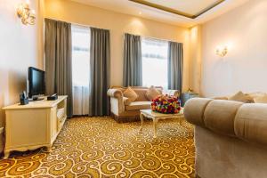 a living room with a couch and a television at Ambassador Hotel in Addis Ababa