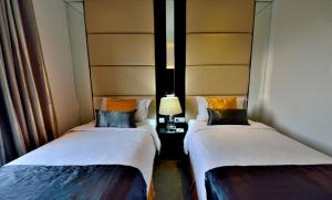 Postel nebo postele na pokoji v ubytování Serela Waringin by KAGUM Hotels