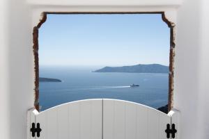 an open door with a view of the ocean at Native Eco Villas in Imerovigli