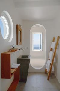 a bathroom with a sink and a window at Native Eco Villas in Imerovigli