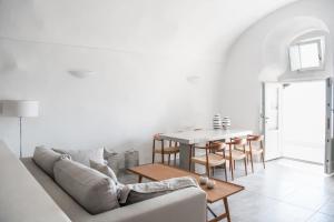 a living room with a couch and a table at Native Eco Villas in Imerovigli