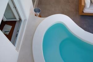 an indoor pool with a blue ball in a room at Native Eco Villas in Imerovigli