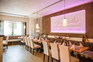 a dining room with a long table and chairs at Hotel Salzburg in Salzburg