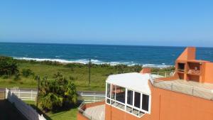 an orange building with the ocean in the background at NO. 2 Avignon in Margate