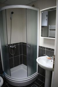a bathroom with a shower and a sink at Toshe in Ohrid