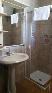 a bathroom with a sink and a shower at Bed and Breakfast Elettra in Marconia