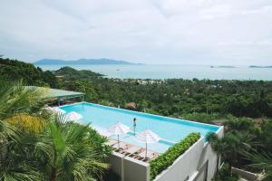 a swimming pool with a view of the ocean at Mantra Samui Resort - Adults Only in Mae Nam