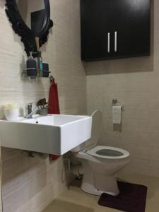 a bathroom with a sink and a toilet at Aurequire in Lagos