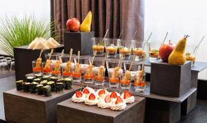 a buffet of food with fruit and other desserts at Centennial Nexus Hotel Tallinn in Tallinn