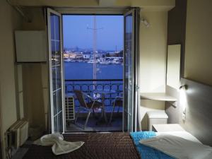 a hotel room with a bed and a view of the water at Olympic Hotel in Kalymnos