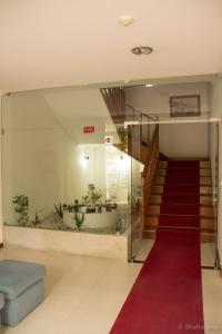 a lobby with a red carpet and a stair case at Hotel Pinheiro Manso in Seara
