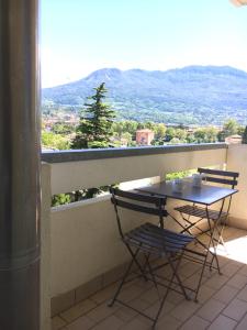 a table and chairs on a balcony with a view at Trento Life in Trento