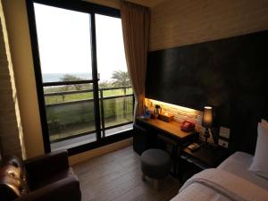 Postel nebo postele na pokoji v ubytování Kenting Moon Bay Hotel