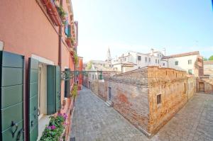 an alley in a city with buildings and flowers at DolceVita Apartments N 394 in Venice