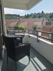 a balcony with a table and chairs on a roof at Apartment Gablenberg in Stuttgart