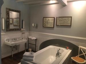 a bathroom with a bath tub and a sink at B&B Number 11 Exclusive Guesthouse in Bruges