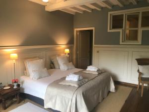 a bedroom with two beds with white sheets at B&B Number 11 Exclusive Guesthouse in Bruges