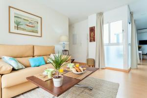 a living room with a couch and a table at Hostly Acetres 1B-2B Center-Fibre-Conmunal terrace-Parking Optional in Seville