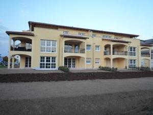 a large yellow building with balconies at PETITE FRANCE Apartment - EP Ticket Garantie in Rust