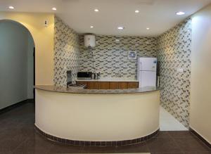 a kitchen with a counter and a refrigerator at Star City Chalets in Az Zulfi