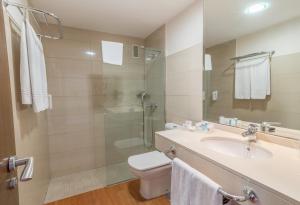 a bathroom with a toilet and a sink and a shower at Hotel LIVVO Corralejo Beach in Corralejo