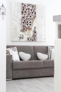 um sofá cinzento com almofadas numa sala de estar em Carducci em Como
