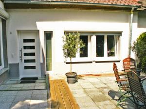 a house with a potted tree on a patio at Ferienwohnung Tannenweg in Baden-Baden